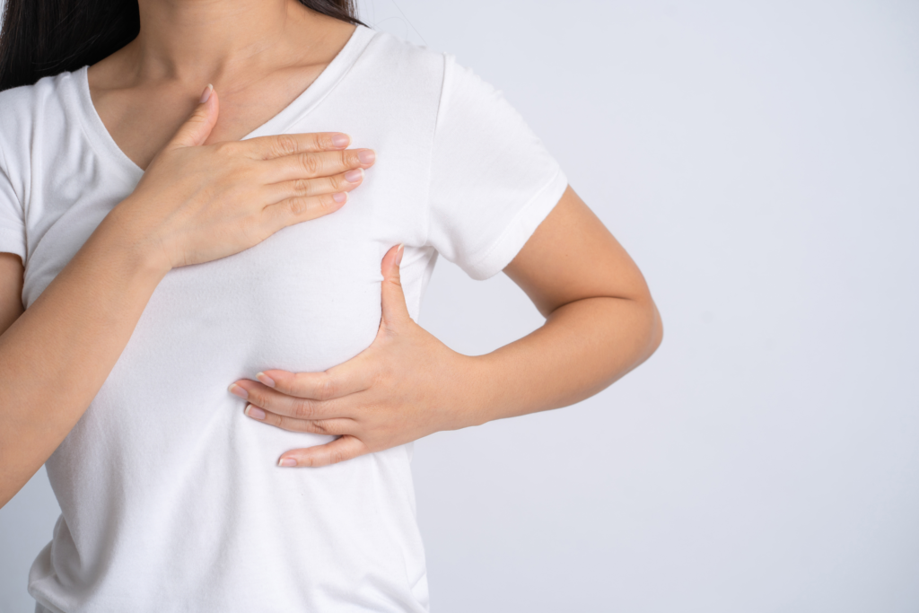 Woman performs self breast exam