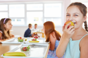 Young girl eating apple