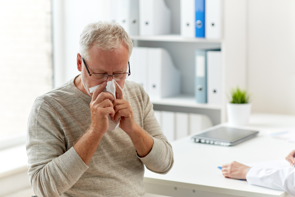 man blowing his nose